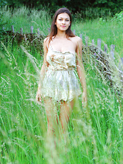 Sofi A teases her amazing breasts out of her little dress in a field of beautiful green grass.